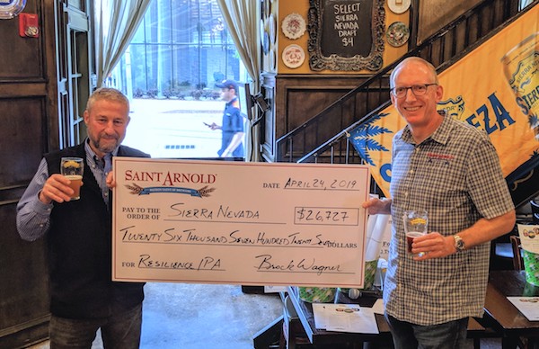 Brock Wagner from Saint Arnold Brewing presents a check to Ken Grossman. The funds were raised from sales of Resilience IPA.